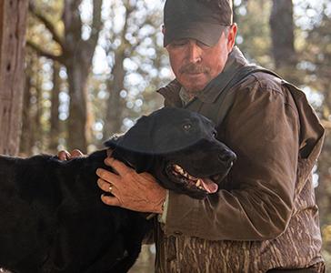 a man holding a dog